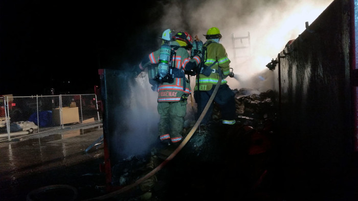 Firefighters from Vernon Central, Vernon Township, and West Mead #1 work at extinguishing a dumpster fire behind Ainsworth Pet Nutrition early Sunday.