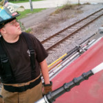 Junior Firefighter Kyle Corey operates the deck gun on Engine 28-11