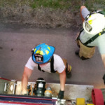 Firefighter Mike Chornack practices pumping Engine 28-11, guided by Assistant Chief Craig Lauer