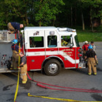 Firefighters repack pre-connected attack lines on Engine 28-13