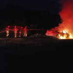 An engine crew advances a 1 3/4" handline to extinguish a car fire along Liberty St