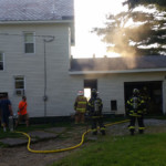 Smoke rises above the garage on Star Route as firefighters check for extension