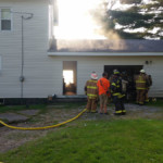 Smoke rises above the garage on Star Route as firefighters check for extension