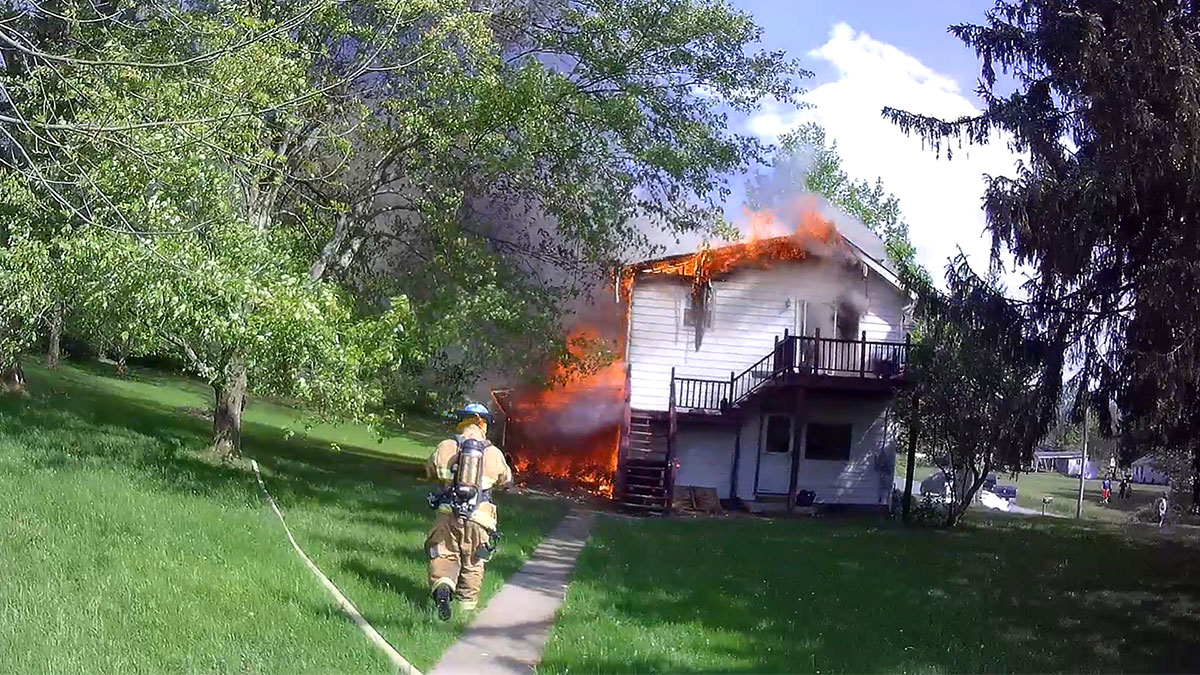 Firefighters Kyle Corey and Dallas Winckler begin a transitional attack on a Pettis Road duplex fire