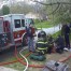 Firefighters provide oxygen to a dog rescued from the second floor