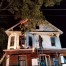 Firefighters from West Mead 2 pull siding from the wood-frame structure on fire
