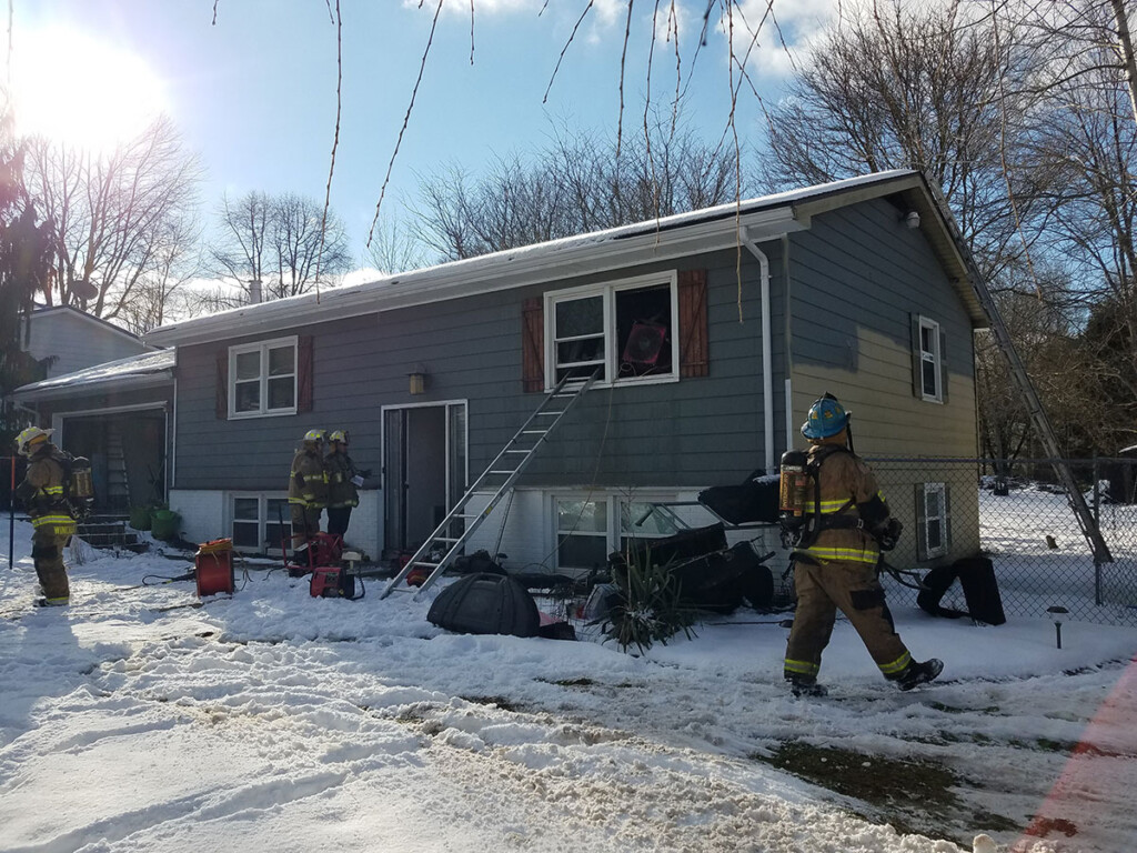 Firefighters complete overhaul on a house with a room and contents fire