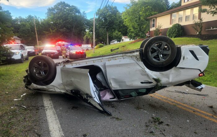 Emergency vehicles on scene of a single-vehicle rollover on Liberty St Extension